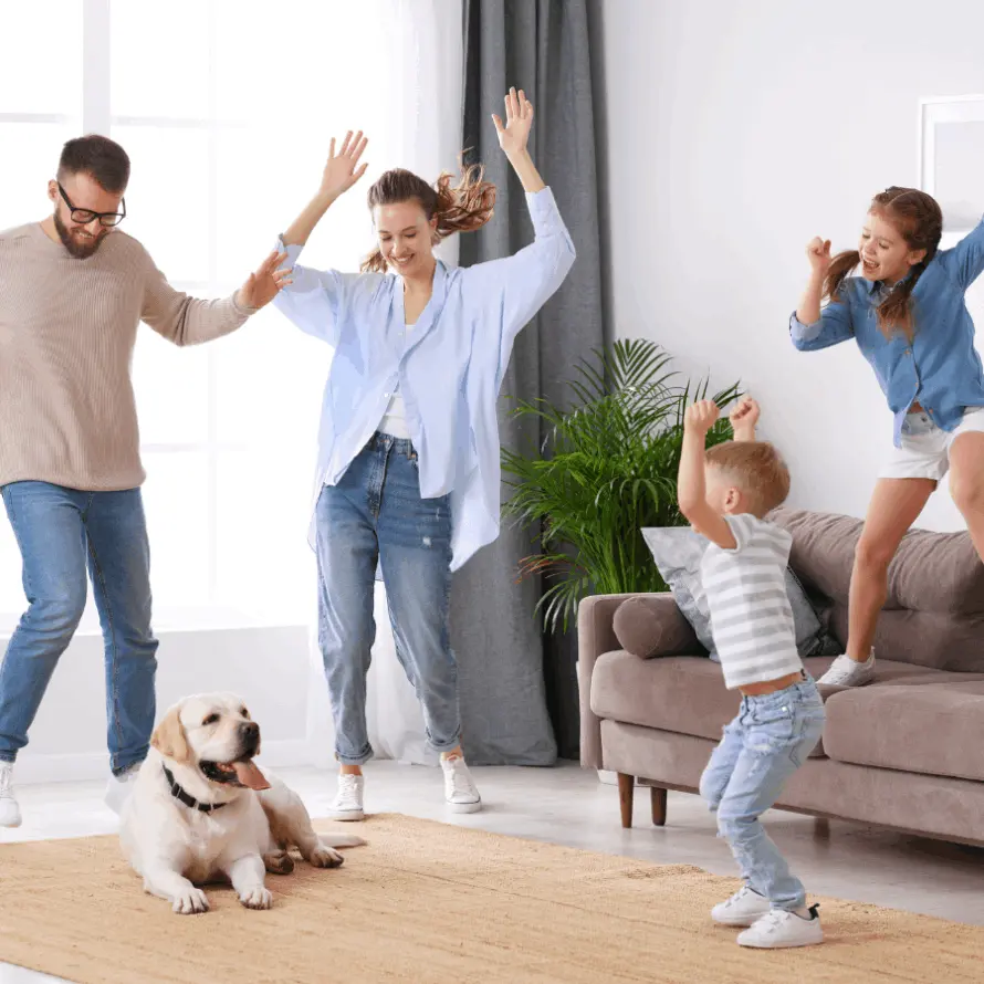 Family dancing on clean carpet and furniture in Burlington, Ontario Cleaned by Ecosuds